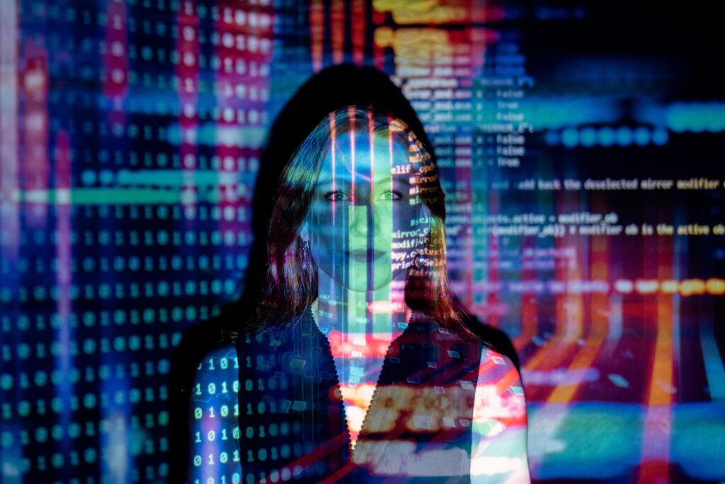 Woman standing with visible code on background.