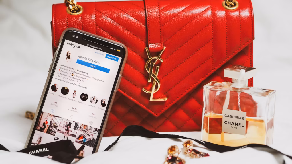 Visible phone with instagram account and a red bag with Channel perfume.