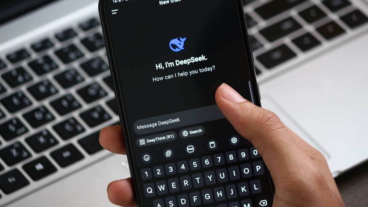 Person interacting with DeepSeek AI chat app on smartphone, focusing on digital innovation and communication.
