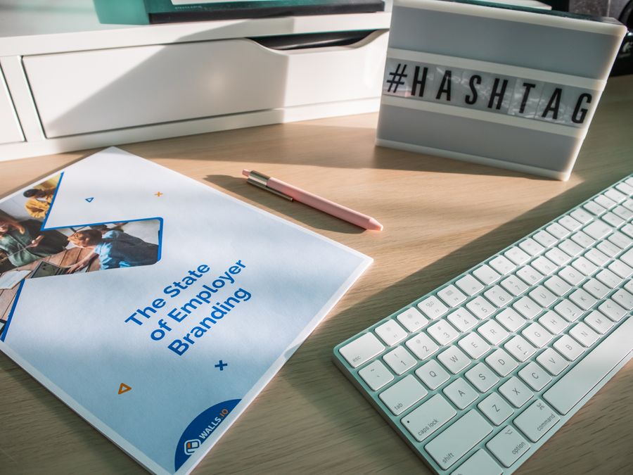 A contemporary workspace with a branding report and hashtag sign highlighting employer branding.