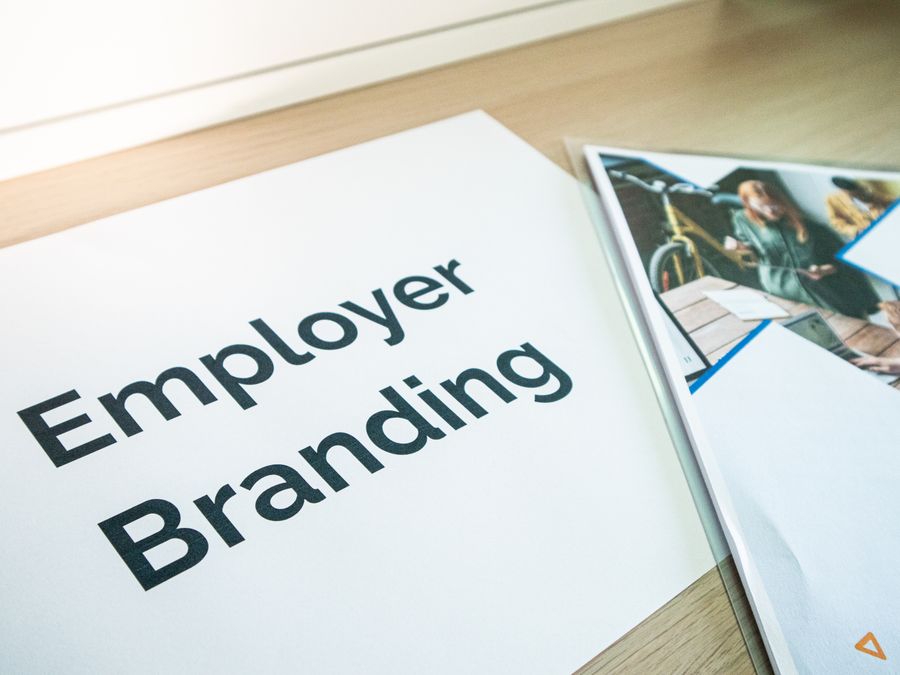 Focus on employer branding with documents on a wooden desk, ideal for business concepts.