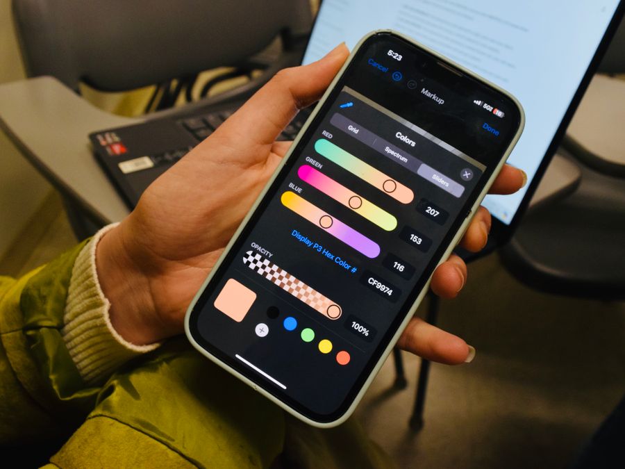 A person browsing a color selection app on a smartphone screen indoors with visible color options.