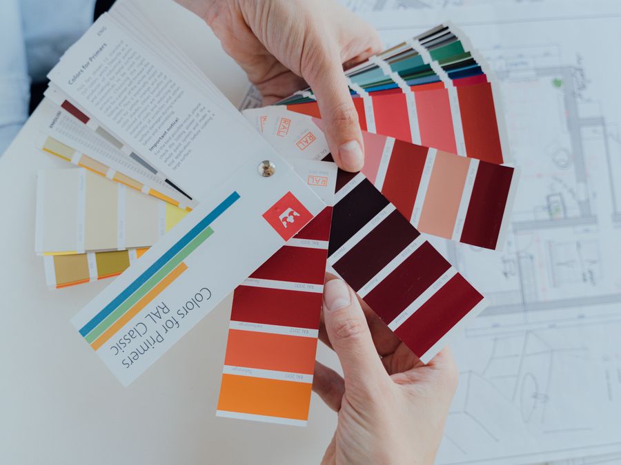 Person choosing color palettes for interior design projects, emphasizing creative choices.