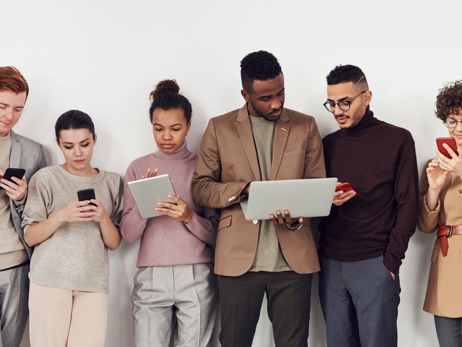 A diverse group of young adults using mobile devices. Perfect for business and technology themes.