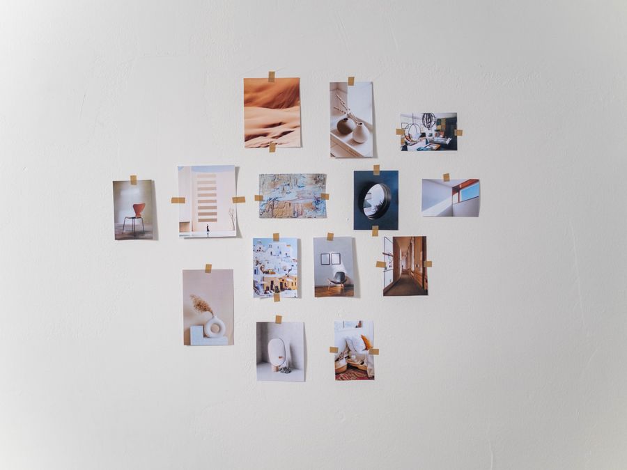 Aesthetic arrangement of photos on a white wall in a minimalist style.