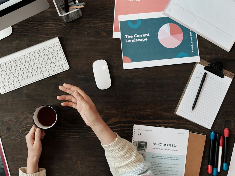 A top view of a workspace with documents, keyboard, and coffee, ideal for business and productivity themes.