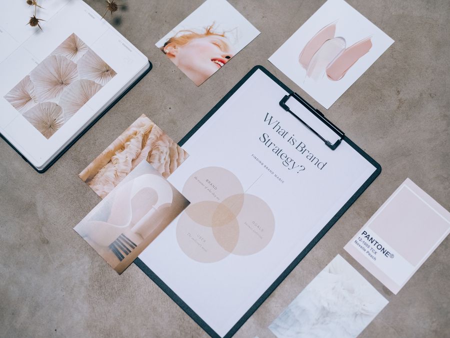 Flat lay showing branding materials and design concepts for creative strategy discussions.