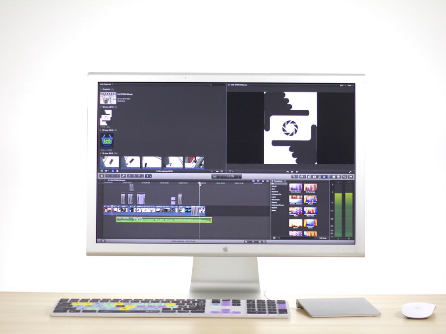 A sleek computer monitor displays video editing software in a modern workspace.