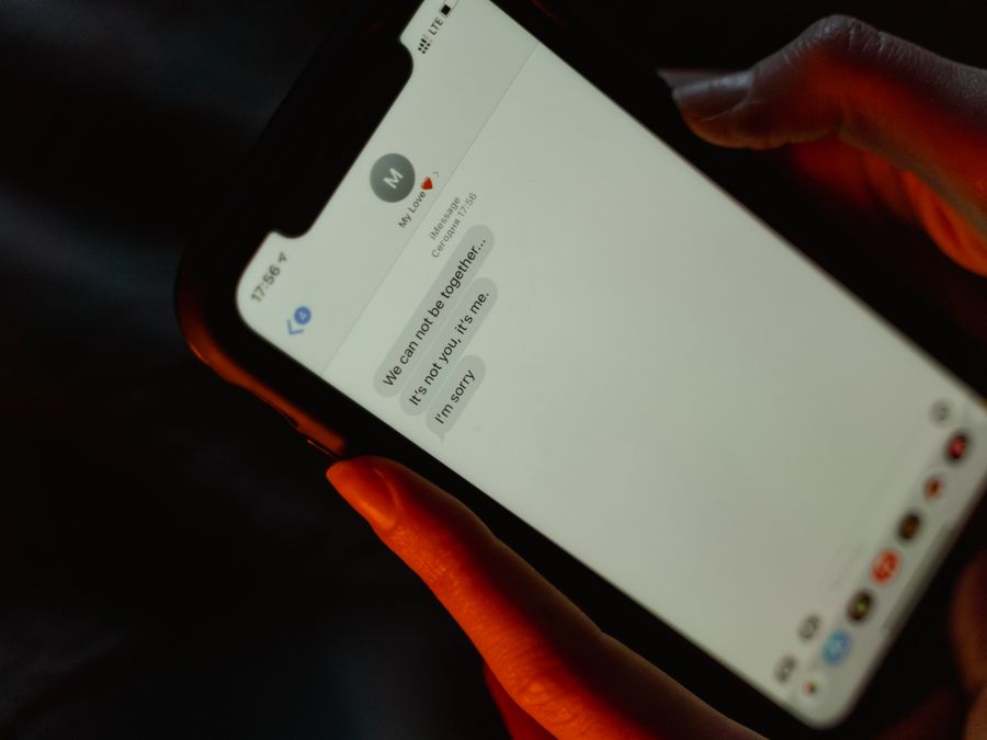 A close-up view of a text message on a smartphone screen displaying a breakup message.