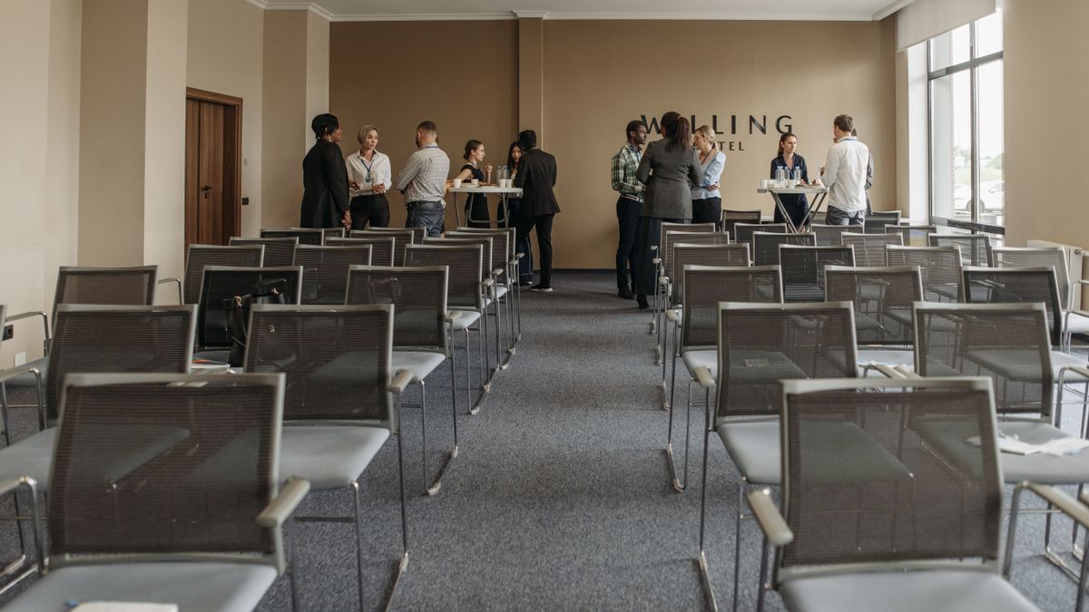 Business professionals networking in a conference room setting.