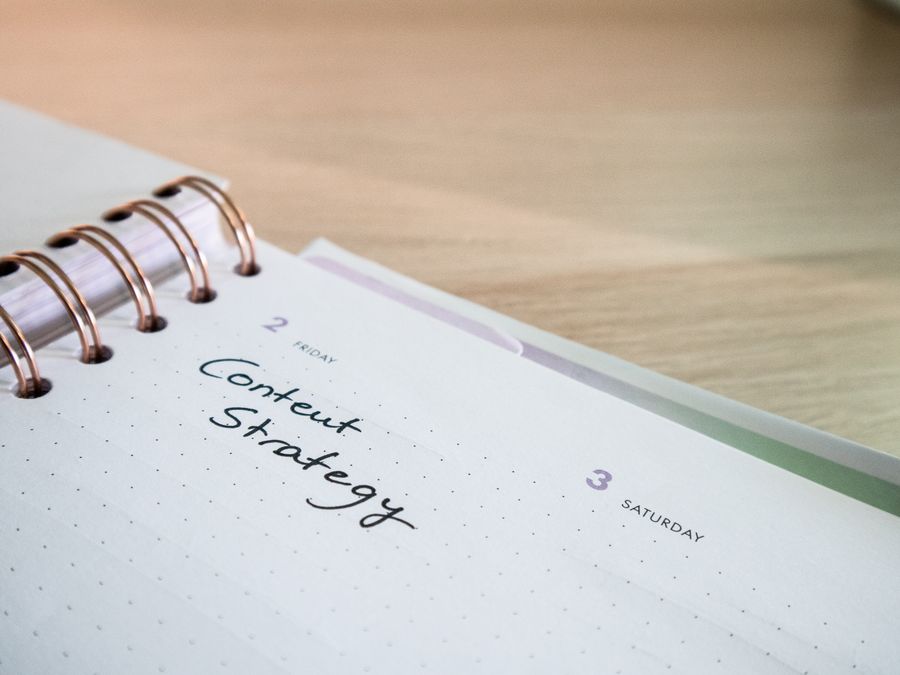 Close-up of a notebook page with 'Content Strategy' written on it, ideal for business planning visuals.