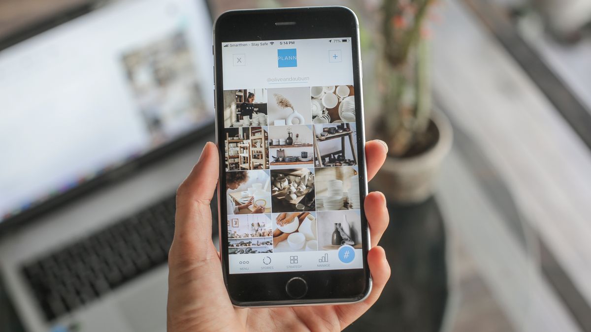 Close-up of a woman using a social media app on a smartphone indoors, showcasing technology in daily life.