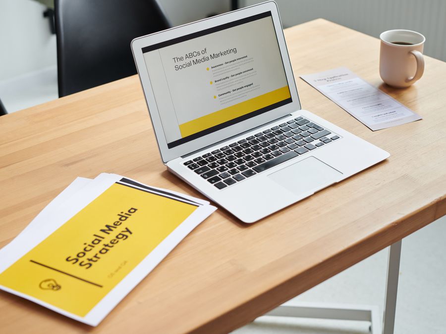 Close-up of a laptop showing a social media marketing strategy in an office setting.