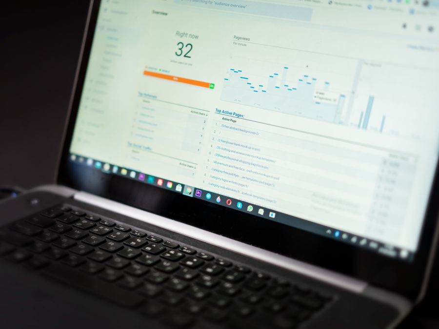 A laptop displaying an analytics dashboard with real-time data tracking and analysis tools.