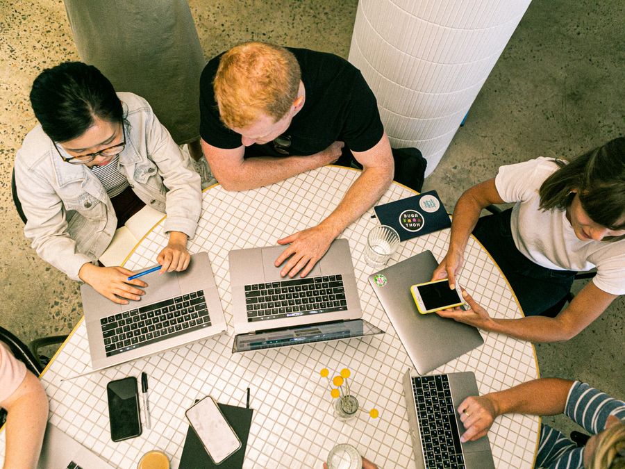 Top view of diverse team collaboratively working in a modern office setting.