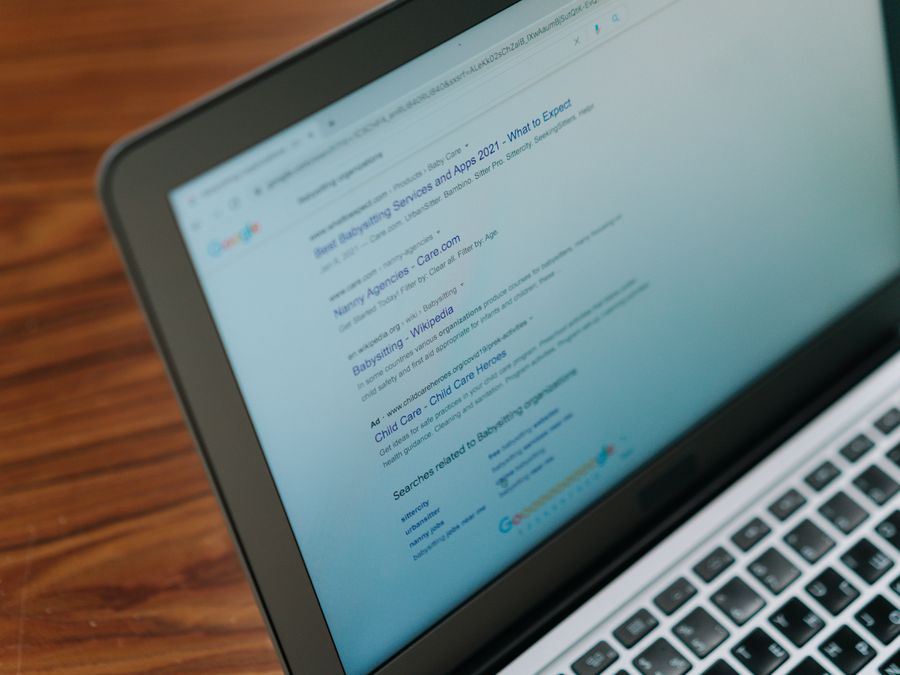 A close-up view of a laptop displaying a search engine page.