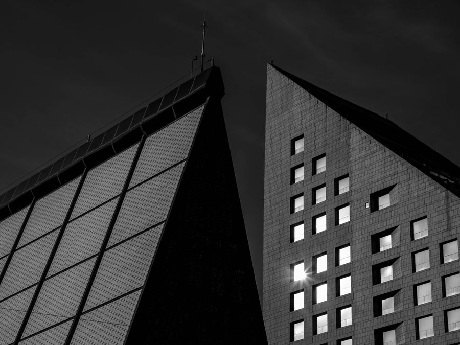 Close-up of geometric modern architectural buildings in black and white.