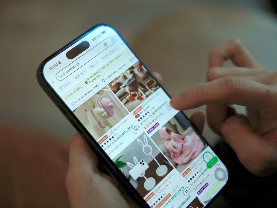 Person browsing shopping app on smartphone, displaying modern ecommerce interface.