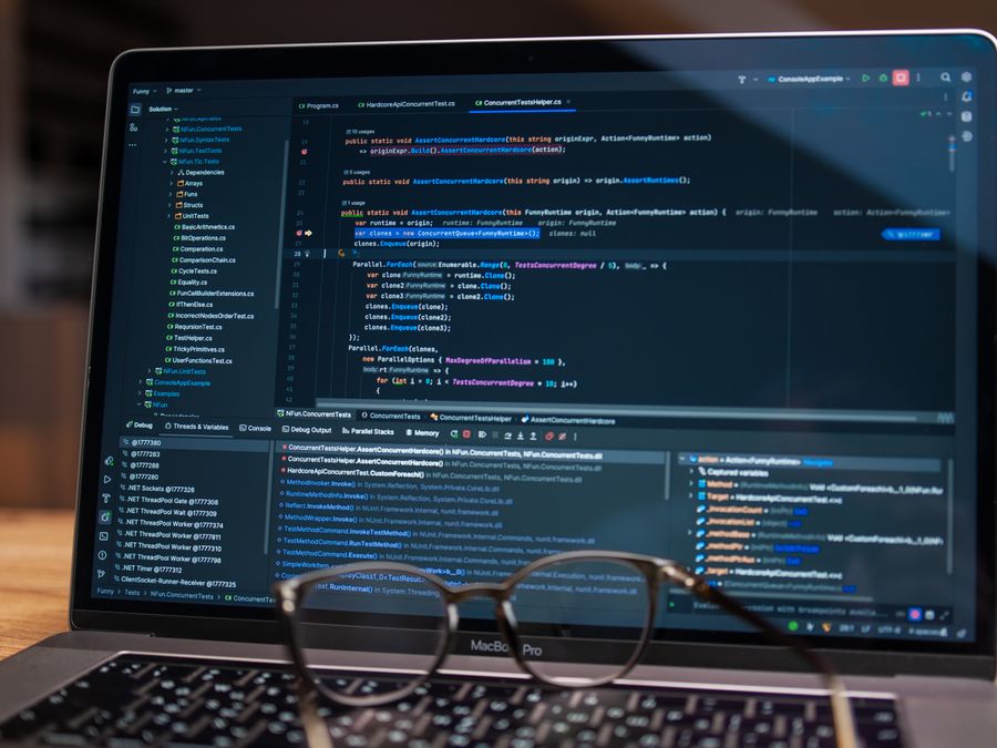 Laptop screen showing debugging software with code, perfect for tech and software development themes.