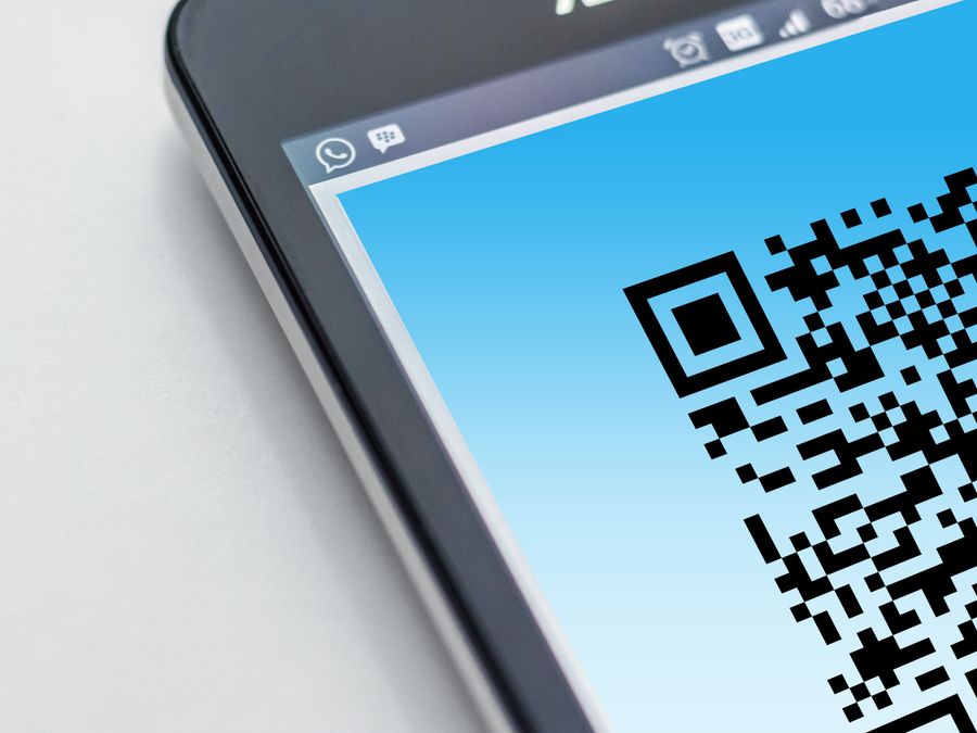 High-resolution close-up of a smartphone displaying a QR code on its screen.